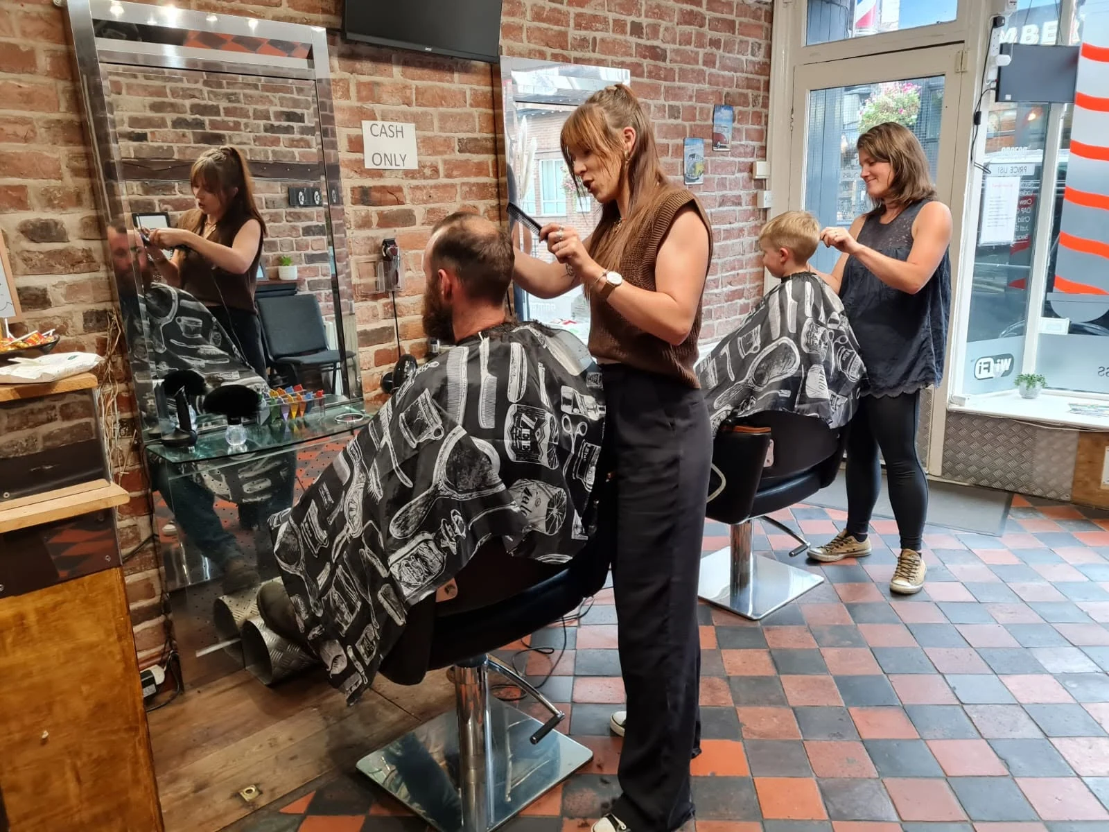 Haircuts underway inside Razors Barber Shop